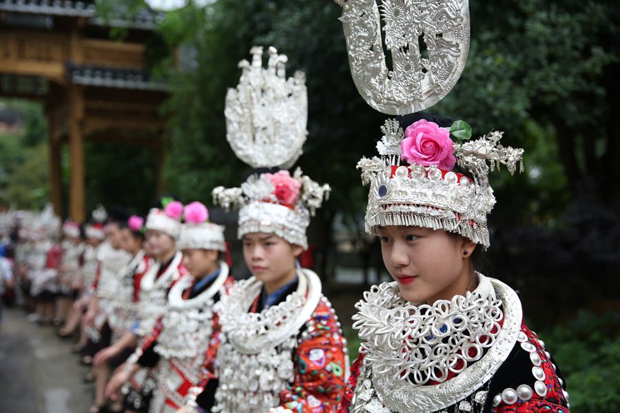 Miao people in traditional costume welcome experts in rural construction