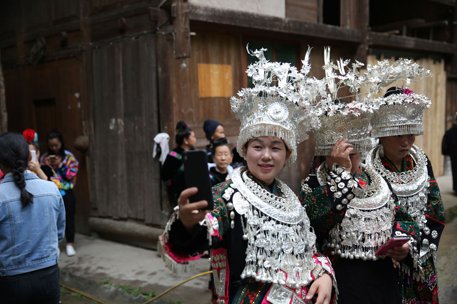 Miao people in traditional costume welcome experts in rural construction