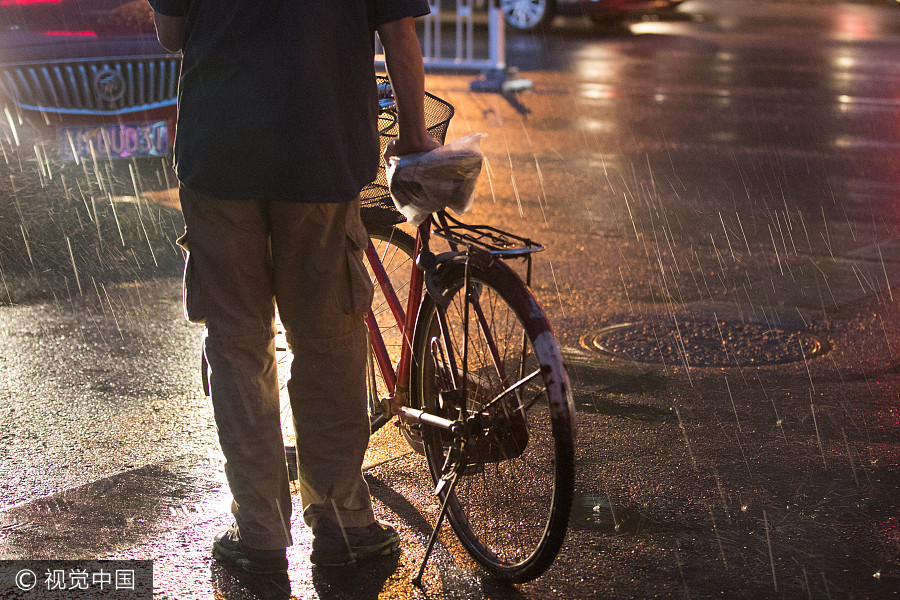 Heavy rains bring respite to scorching Beijing