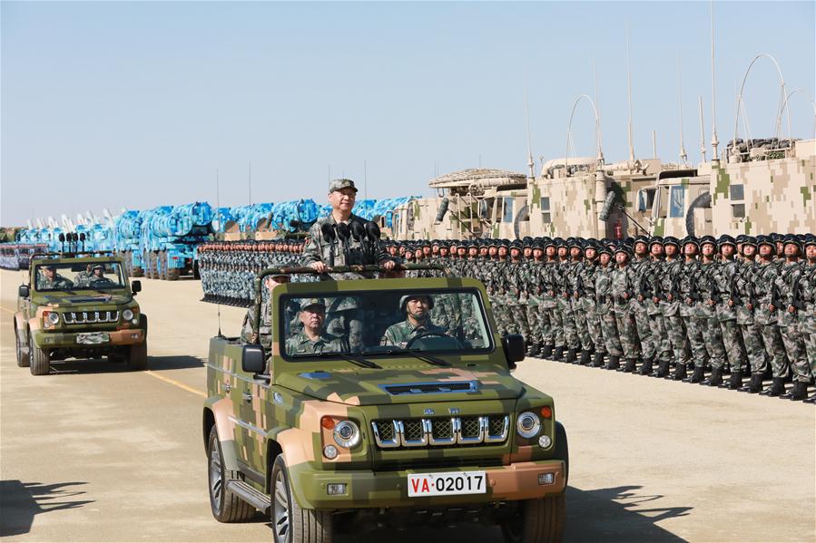 Xi reviews parade in field for first time