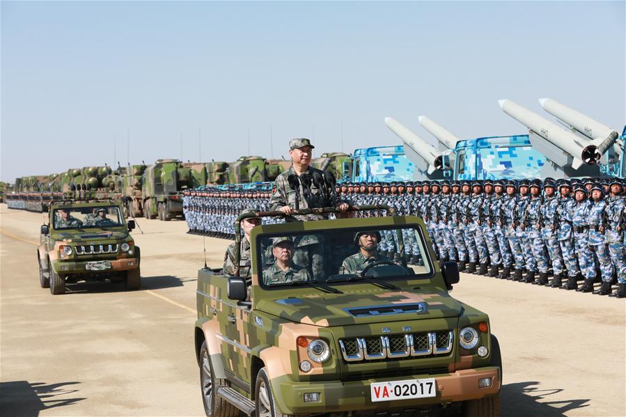 Xi reviews parade in field for first time