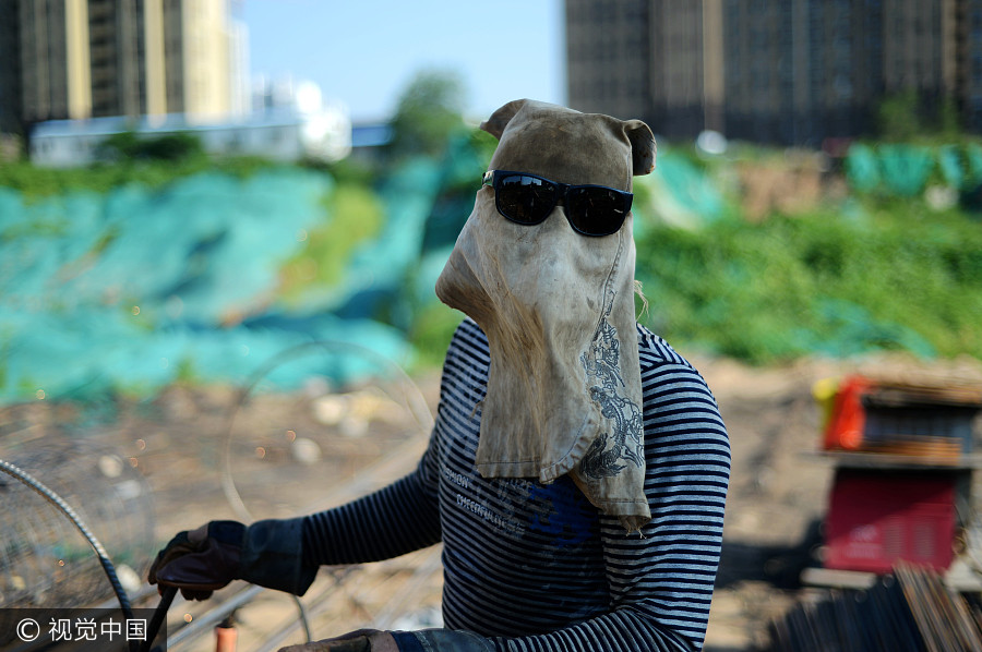 Welders cover up despite summer heat