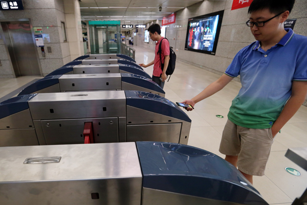 In Beijing, swipe phone, board subway