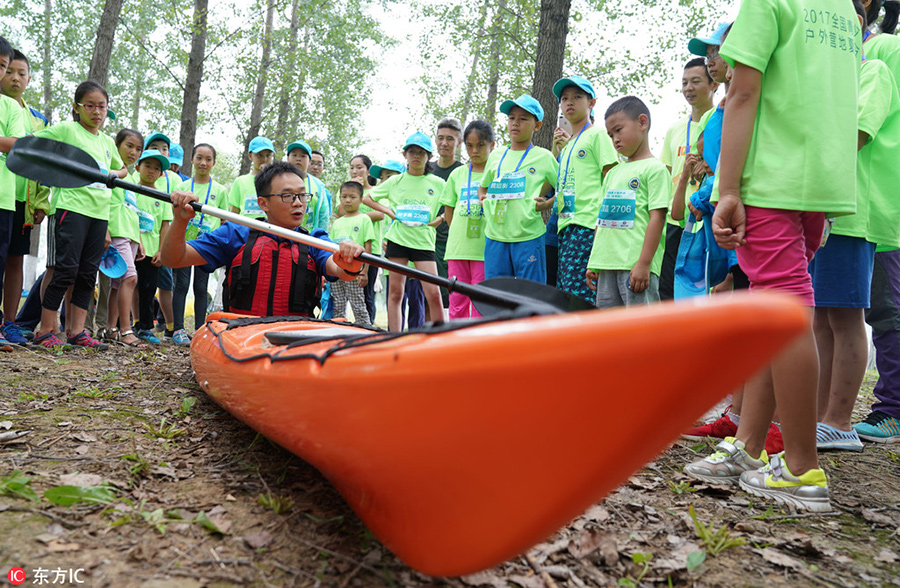 Children test survival skills in woods and on water