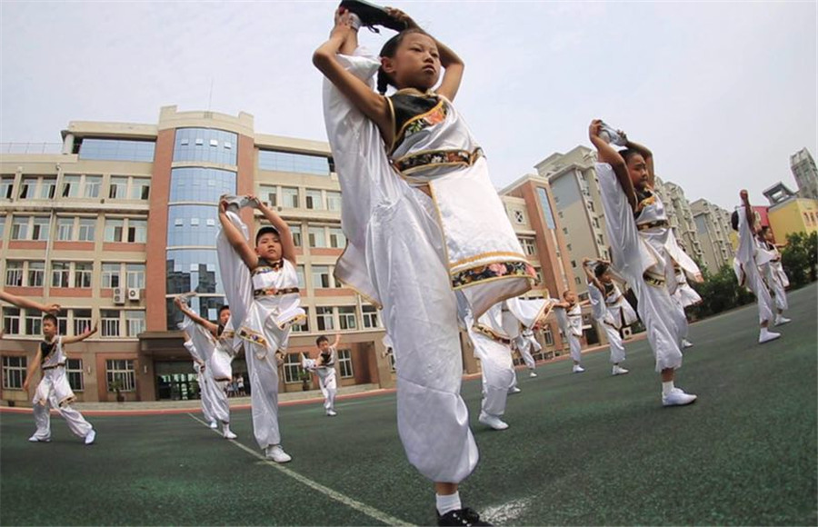 Students practice martial arts during class brea