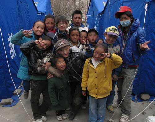 Children grimace, smile in quake zone