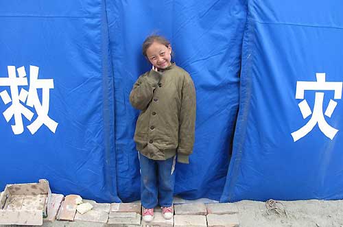 Children grimace, smile in quake zone