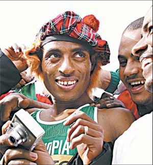 Relieved Bekele triumphs while wife watches