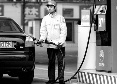 inthetank,inthekitchen attendant at petrochina gas station fills customer"s tank in