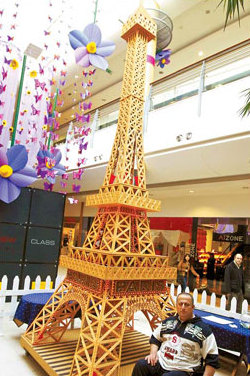 Eiffel Tower gets new coat on birthday