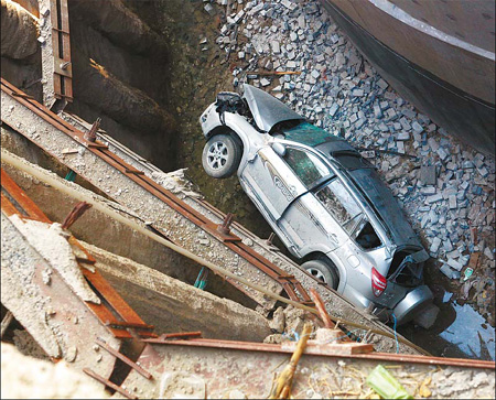 Driver escapes fall with injuries