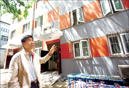 Recycler scraps for debris as building waste piles up