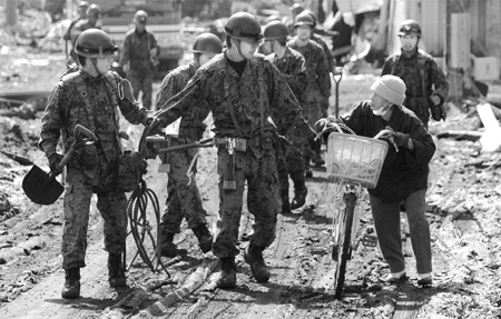 Japan begins to dig for dead amid devastation