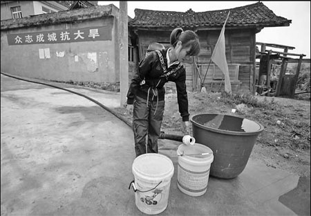 Hose begins taking water to dry village