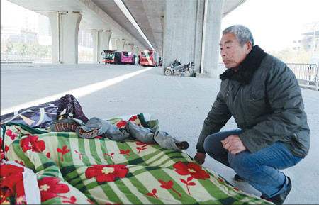 Migrant workers shelter beneath overpasses