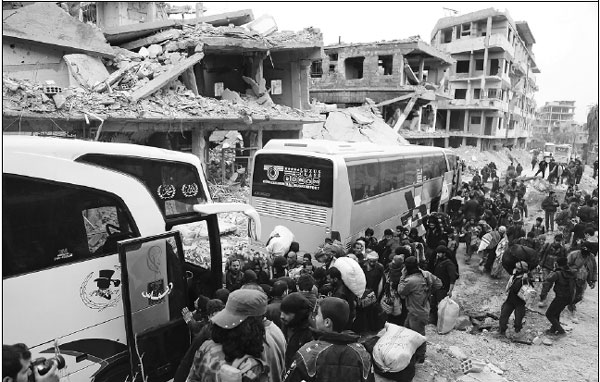 Syrian rebels begin enclave evacuation