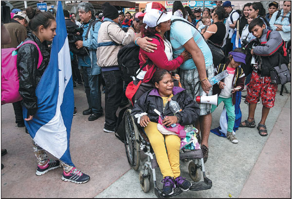 First 'caravan' migrants start asylum process