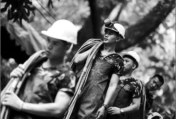 Rescuers race to drain water to save 12 trapped boys, coach in Thailand