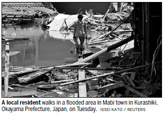 At least 156 dead as Japan searches for missing