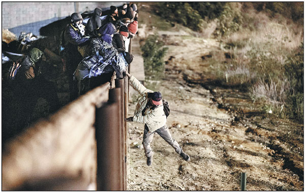 US fires tear gas as migrants storm border