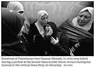 Outraged Palestinian mourners bury 2 teens killed by Israeli gunfire near Gaza's border