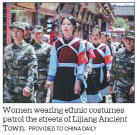 Women in ethnic costumes patrol Lijiang Ancient Town