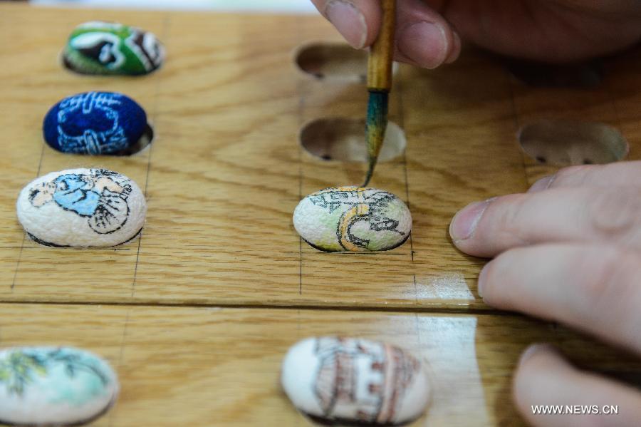 Art teacher creates unique paintings on silkworm cocoons