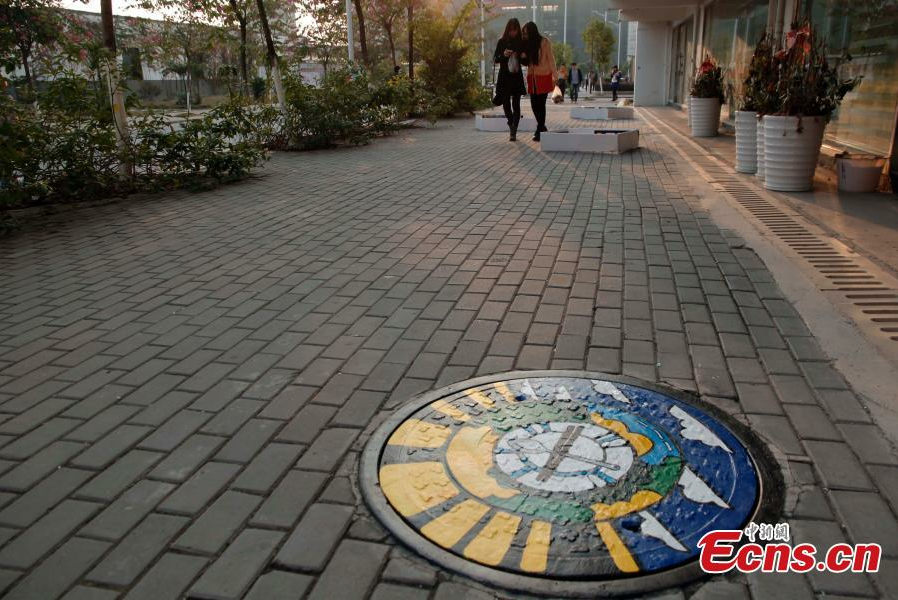 Students paint dream on manhole covers