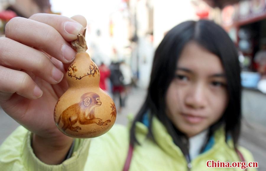 Monkeys on artist's gourd pyrography