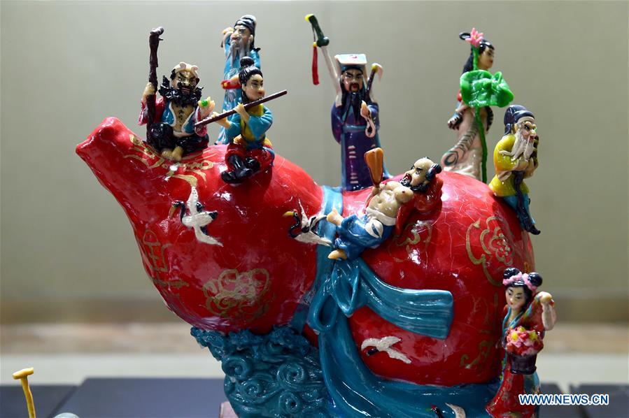 Delicate dough figurine work presented at craft workshop in Shandong