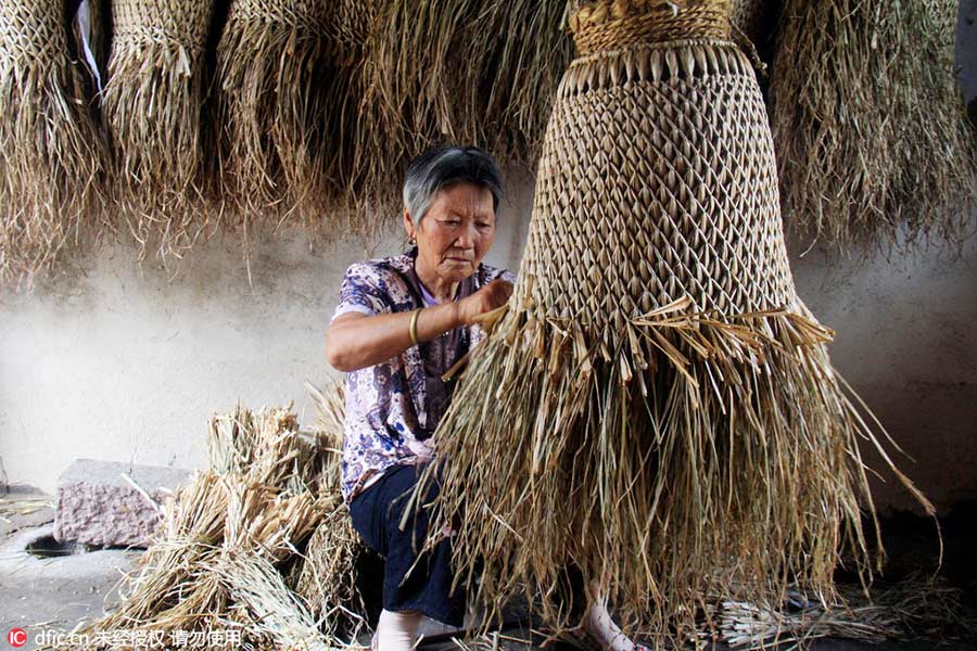 Woman keeps art of making straw rain cape alive