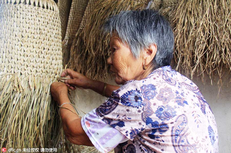 Woman keeps art of making straw rain cape alive