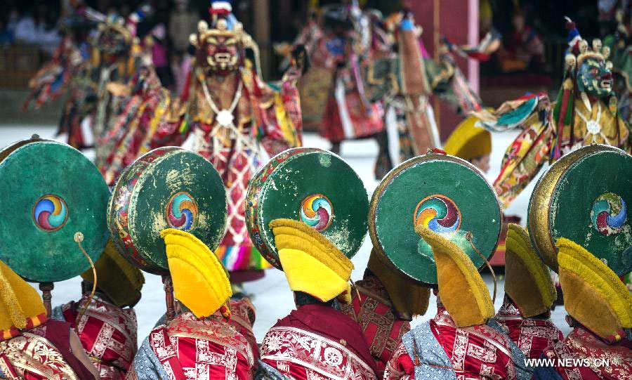 Tibetan Buddhist monks perform to greet Tibetan New Year