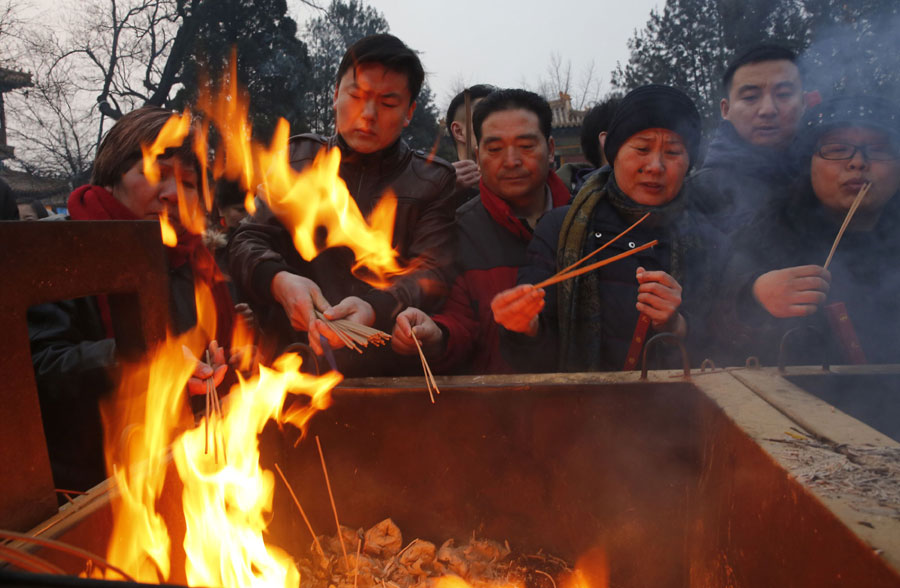 People pray on the first day of Chinese New Year