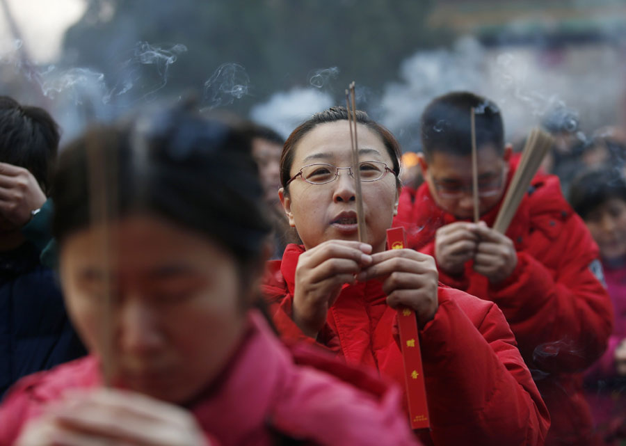 People pray on the first day of Chinese New Year