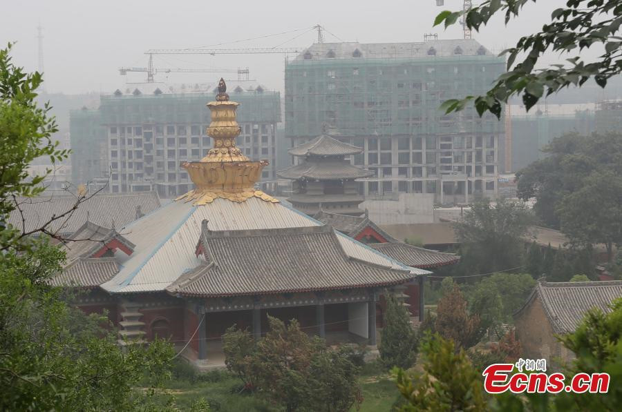 1,800-year-old temple under siege from high buildings in C China