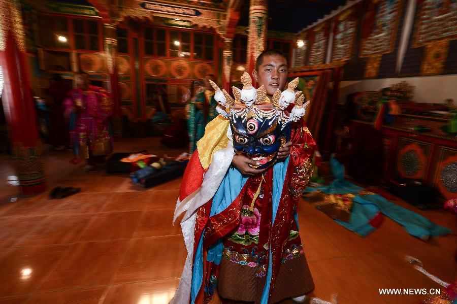 Monks wearing masks rehearse Gesar opera at Chalang Temple in NW China