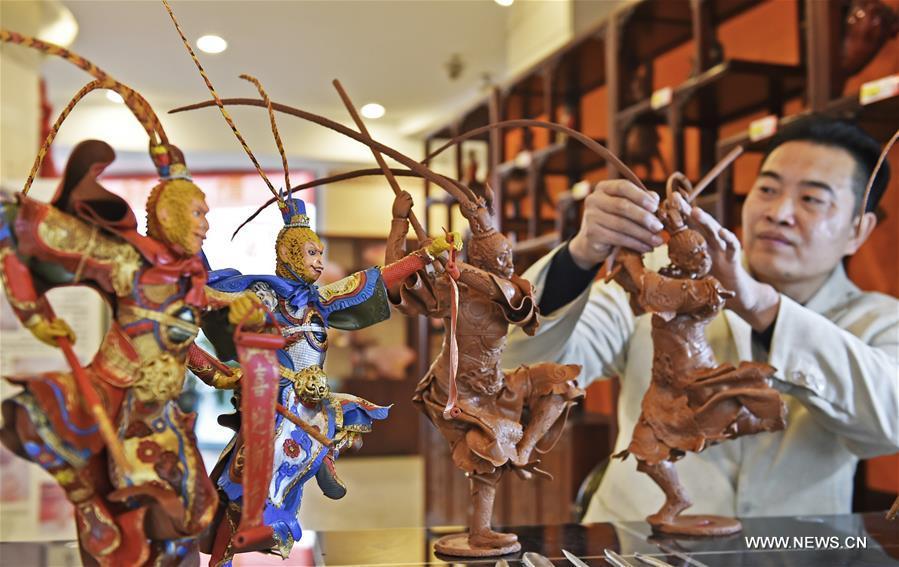 Folk artist makes sculptures of Monkey King to greet Chinese Lunar New Year