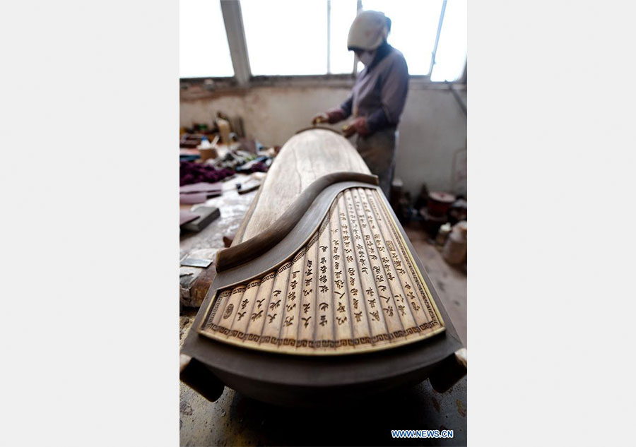 Workers make Chinese traditional music instruments Guzheng in Henan