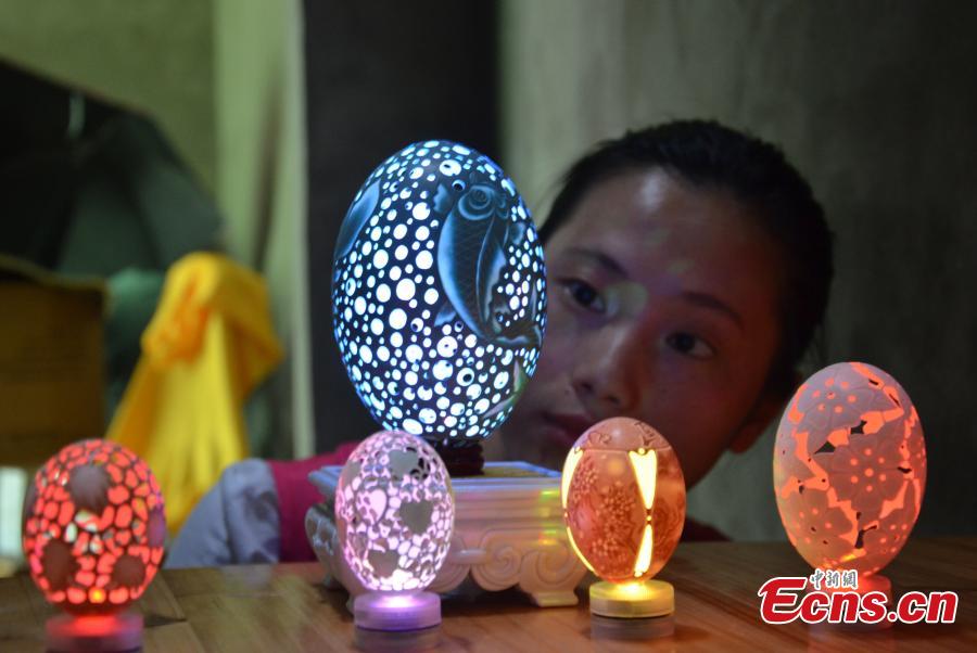 Disabled woman empowered by egg shell carving