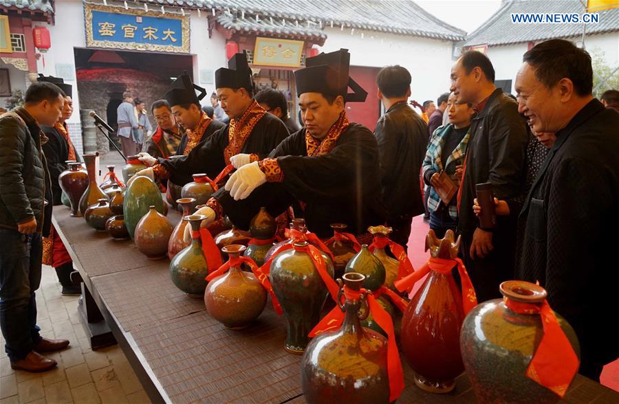 Ceremony taking porcelains out of kiln held in central China