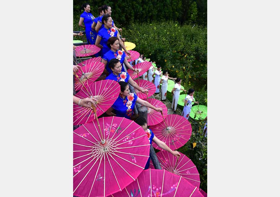 Women present traditional dress cheongsam in Hubei