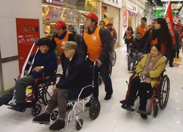 成都高新区举办公共设施无障碍体验活动 志愿者陪残疾人逛商场