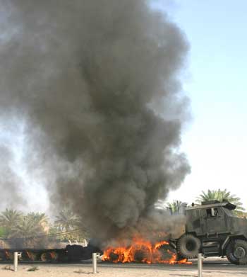 A US army truck burns on the motorway west of the Iraqi capital Baghdad on September 7, 2004. A roadside bomb blast near Baghdad late on Monday killed one US soldier and wounded another, the US military said on Tuesday. The attack will raise the official Pentagon U.S. death toll to at least 989 since the start of the war in Iraq. [Reuters]