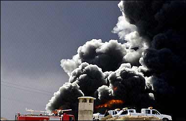 Police cars 
 
 
 
 
 and 
 fire truck are seen parked in front of heavy black smoke billowing from a sabotaged key pipeline pumping oil exports from northern Iraq to Turkey and a local supply line west of the main northern oil capital of Kirkuk. [AFP] 