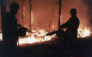 More than 400 armed policemen fight a fire yesterday in Northeast China's Heilongjiang Province. The police contingent was sent on Sunday to control the blaze that started on Friday. The cause of the fire is still under investigation. [China Daily]