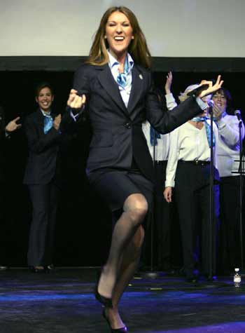 Celine Dion performs for Air Canada employees wearing their newly unveiled flight attendant uniforms in Montreal, October 19, 2004. [Reuters]