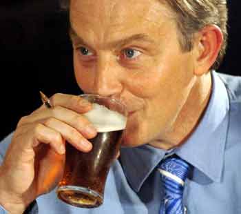 Britain's Prime Minister Tony Blair sips a drink during a question and answer session with local residents at the Spitfire Pub in Thornaby, Teesside, northern England October 21, 2004. Britain agreed on Thursday to send troops to dangerous areas near Baghdad, a politically perilous step for Blair who could face a sharp backlash if casualty rates start rising. [Reuters]