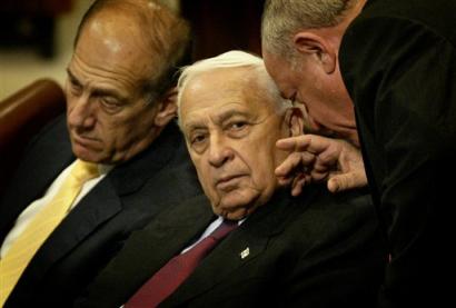 Israeli Prime Minister Ariel Sharon confers with an unidentified official during a special session in the Knesset, Israel's parliament, about his government's proposed 'disengagement plan' in Jerusalem Monday, Oct. 25, 2004. Sharon told the parliament he is determined to press ahead with his plan to withdraw from the Gaza Strip and part of the West Bank, but remains open to peace talks with the Palestinians after their violent uprising ends. At left is Deputy Prime Minister Ehud Olmert.[AP]