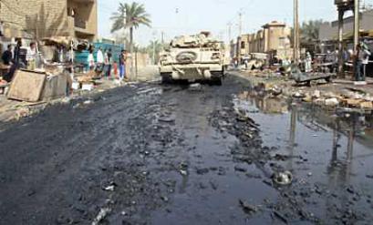 A U.S. Bradley armored vehicle patrols a street in Baghdad's Shi'ite suburb of al-Sadr city during a military search operation, October 24, 2004. The Pentagon is considering increasing the U.S. force in Iraq for the January elections by delaying the departure of some troops and speeding the arrival of others, U.S. officials said on October 26. [Reuters]